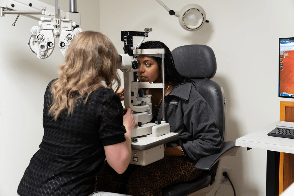 Eye doctor examining a patient’s eyes using a slit lamp during an eye exam